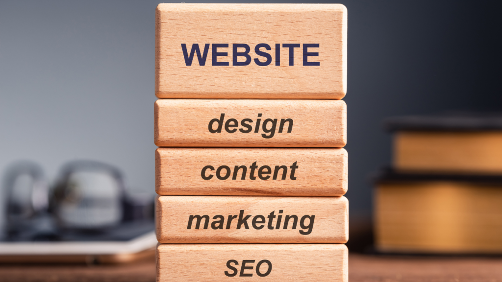 A stack of wooden blocks showing the key components of a successful chiropractic website: "WEBSITE," "design," "content," "marketing," and "SEO."